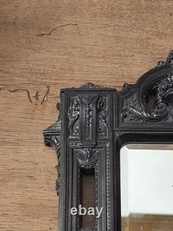 Miroir Napoléon III XIXe siècle bois noirci riche décor glace biseautée