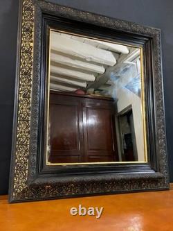 Miroir XIXe Napoléon III en bois noirci sur fond or