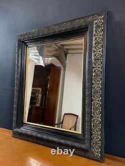 Miroir XIXe Napoléon III en bois noirci sur fond or