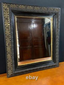 Miroir XIXe Napoléon III en bois noirci sur fond or