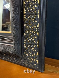 Miroir XIXe Napoléon III en bois noirci sur fond or