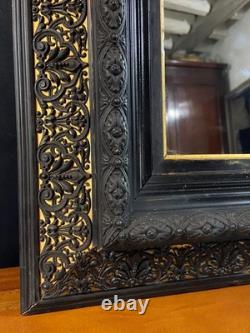 Miroir XIXe Napoléon III en bois noirci sur fond or