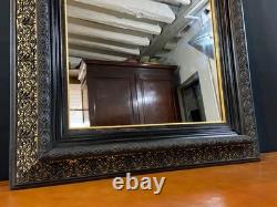 Miroir XIXe Napoléon III en bois noirci sur fond or