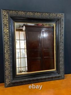 Miroir XIXe Napoléon III en bois noirci sur fond or