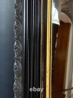 Miroir XIXe Napoléon III en bois noirci sur fond or