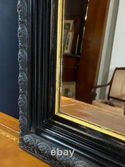 Miroir XIXe Napoléon III en bois noirci sur fond or