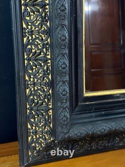 Miroir XIXe Napoléon III en bois noirci sur fond or