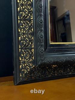 Miroir XIXe Napoléon III en bois noirci sur fond or