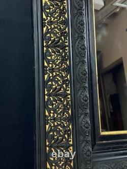 Miroir XIXe Napoléon III en bois noirci sur fond or