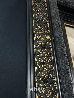 Miroir XIXe Napoléon III en bois noirci sur fond or