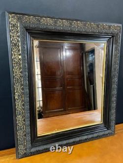 Miroir XIXe Napoléon III en bois noirci sur fond or