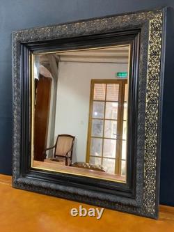 Miroir XIXe Napoléon III en bois noirci sur fond or