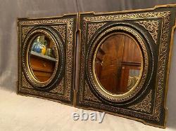 Paire de miroir à vue ovale bois et stuc décor doré fond noir XIXe Napoléon III