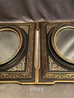 Paire de miroir à vue ovale bois et stuc décor doré fond noir XIXe Napoléon III